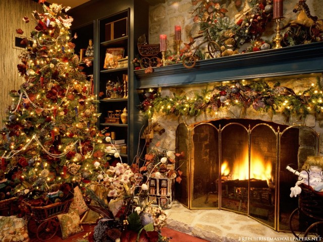 A beautiful Christmas tree near a fireplace.