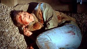 Aaron hides below the railway tracks before he is apprehended by the police.